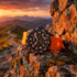 JAG Beachport black dial orange sport chronograph men's watch sitting on a rock face on an outdoor trail.
