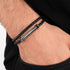 Man wearing Police Bolt Black Leather Bracelet