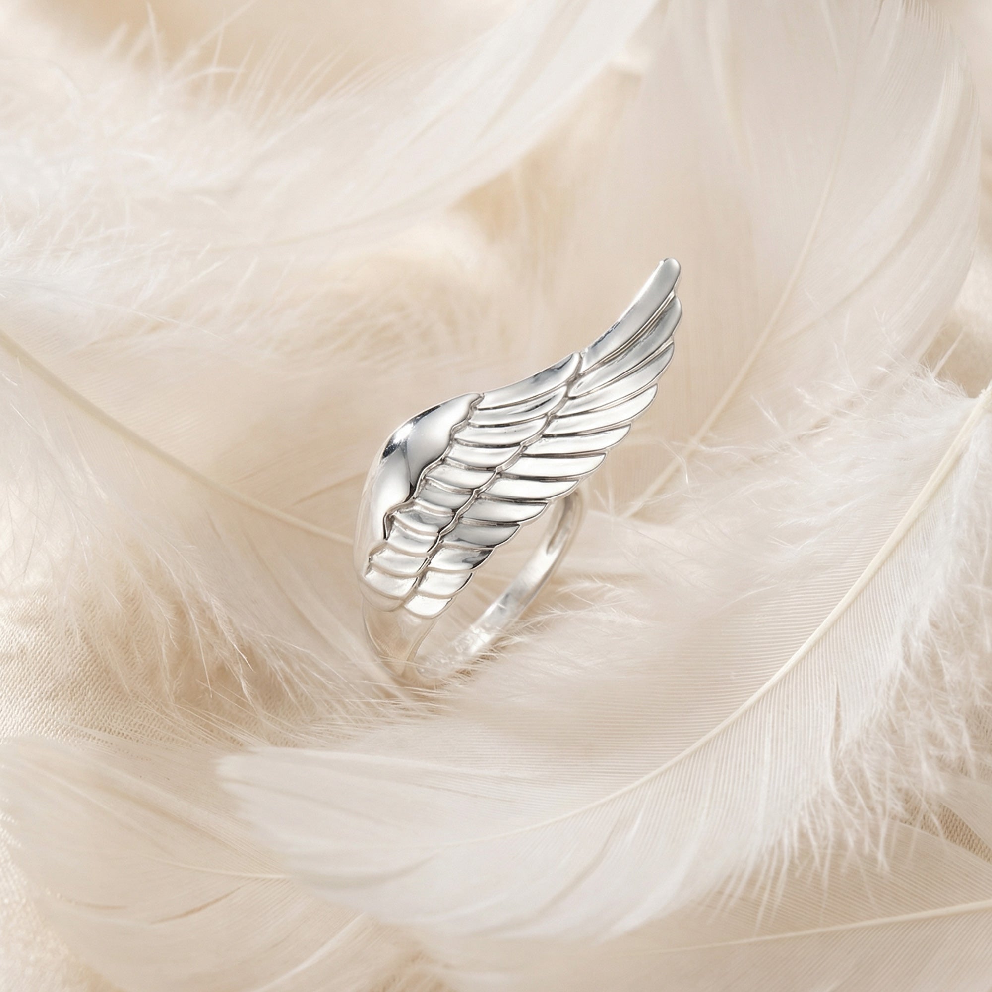 Engelsrufer Silver Adjustable Angel Wing Ring Laying On White Feathers