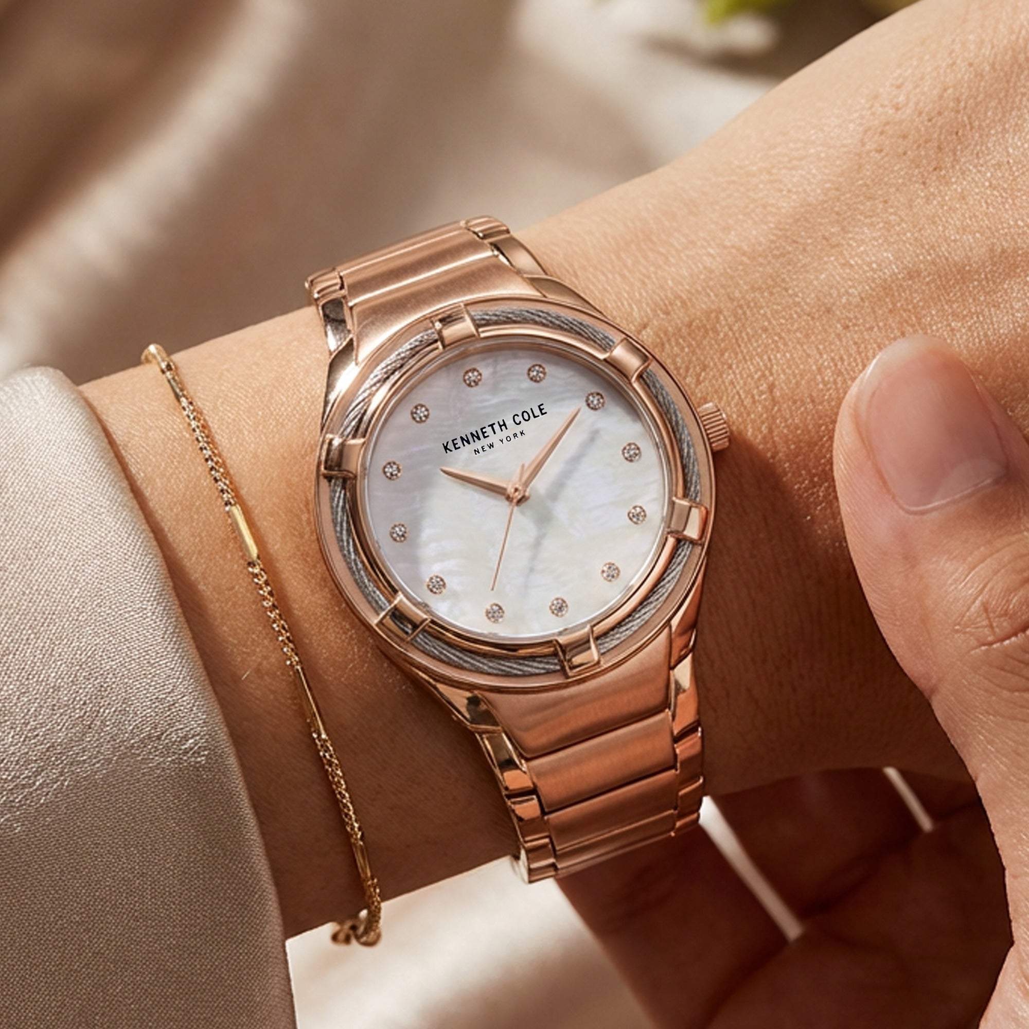 Woman Wearing Kenneth Cole Rose Gold Mother Of Pearl Halo Ladies Watch