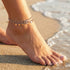 Woman Wearing Hearts & Beads Steel Boho Anklet At The Beach
