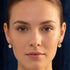 Woman wearing Engelsrufer sun moon & star gold earrings.