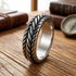 Stainless Steel Men's Twisted Rope Ring On Wooden Desk