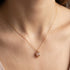 Woman Wearing Rose Quartz Infinity Cage Gold Necklace