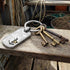 World Map Anchor Dog Tag Men's Steel Key Ring Sitting On Shelf In Fishing Boat