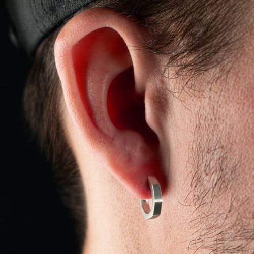 ManWearing Steel Hexagon Men’s Huggie Hoop Earring