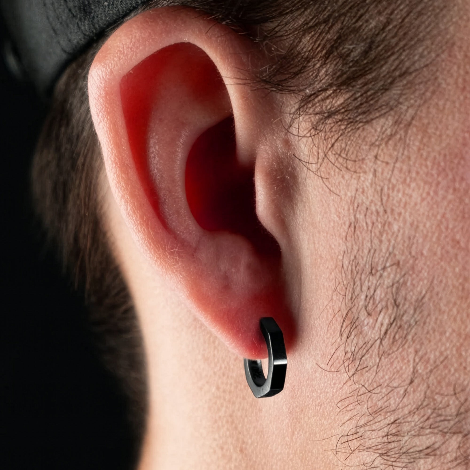 Man Wearing Steel Black Hexagon Men’s Huggie Hoop Earring
