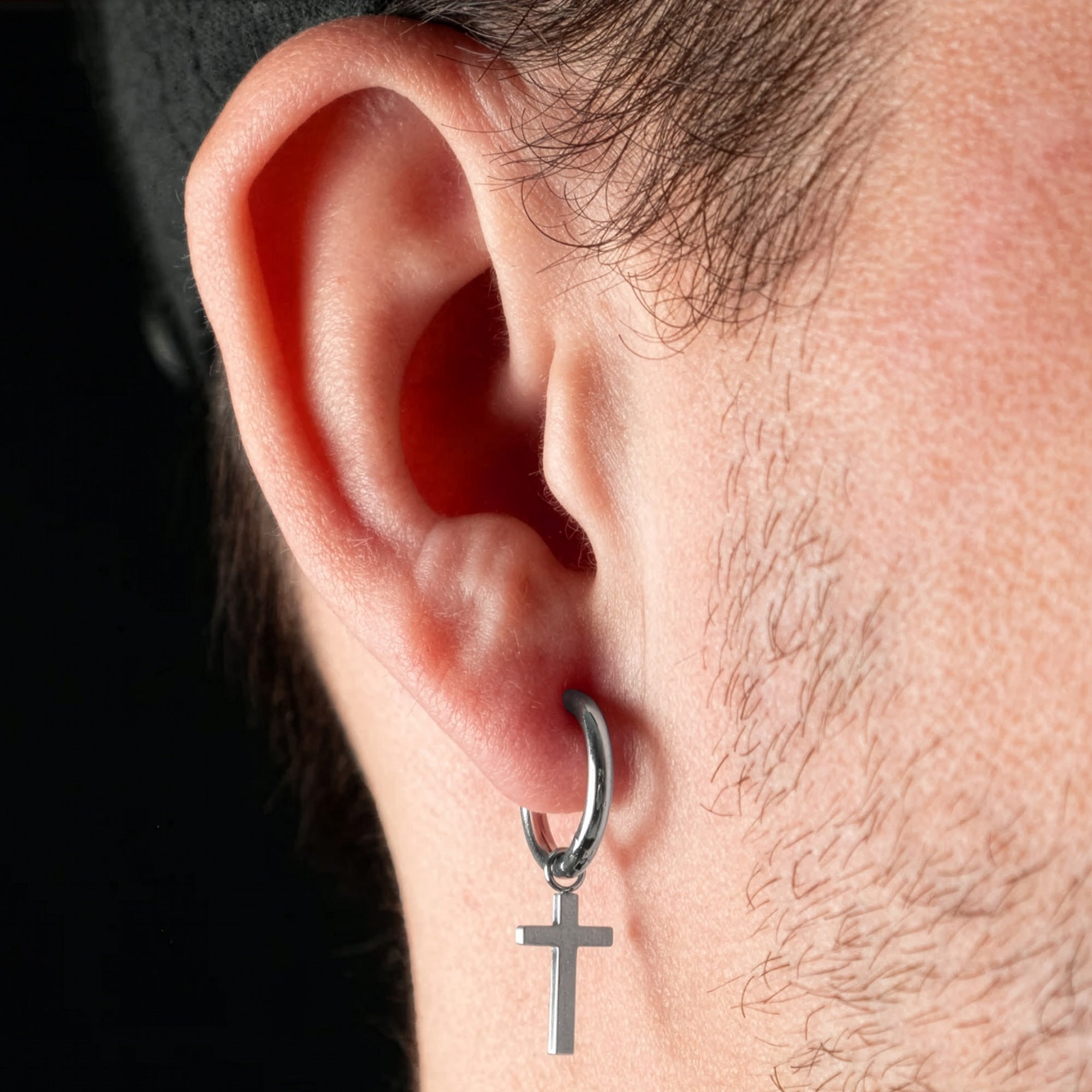 Man Wearing Steel Dangle Cross Men’s Hoop Earring