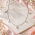 Engelsrufer faith love hope sterling silver charm necklace on a marble slice.
