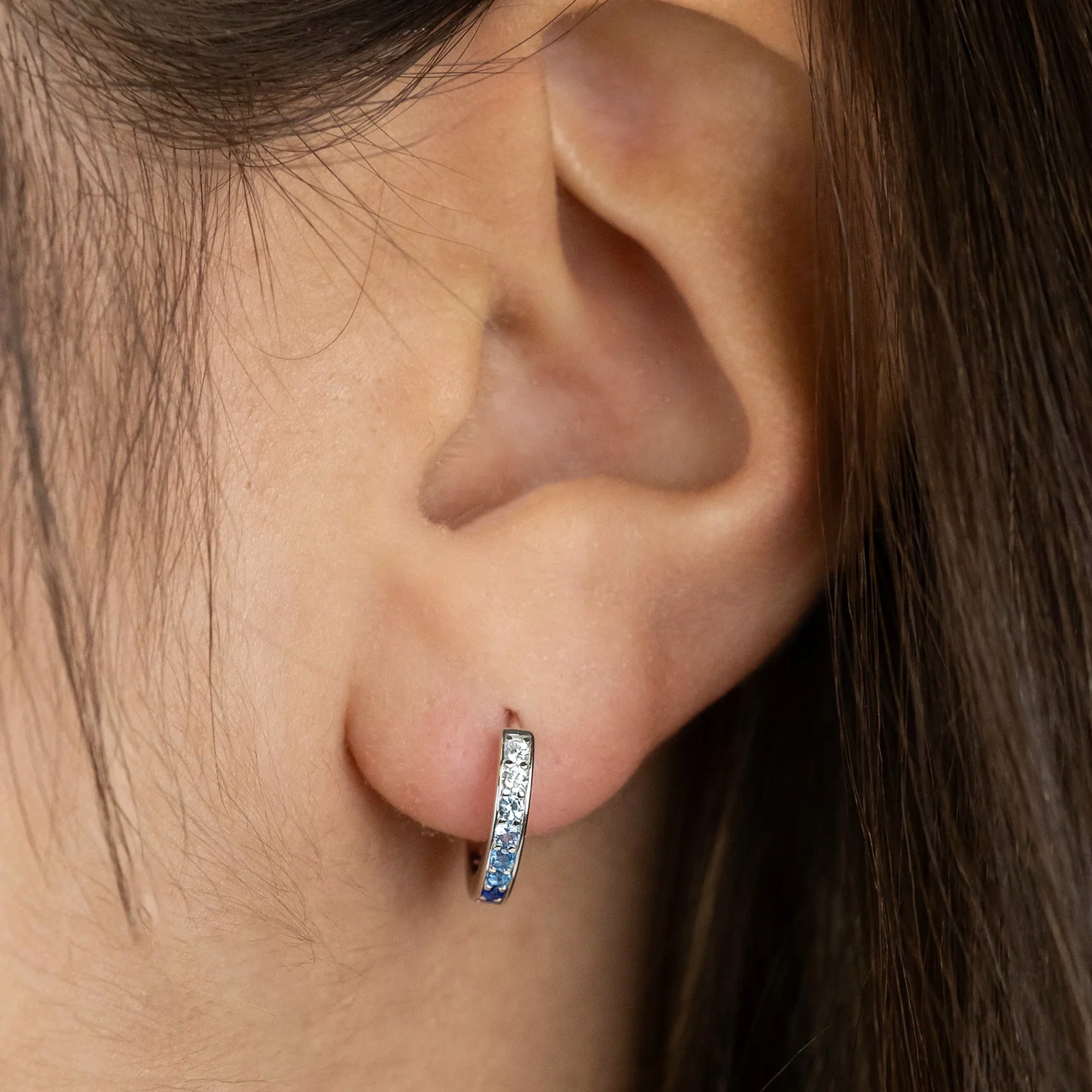 Woman Wearing Sterling Silver Ocean Blue 13mm CZ Hoop Earrings