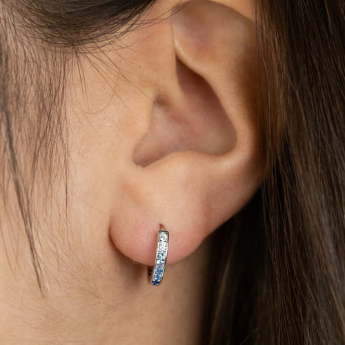 Woman Wearing Sterling Silver Ocean Blue 13mm CZ Hoop Earrings