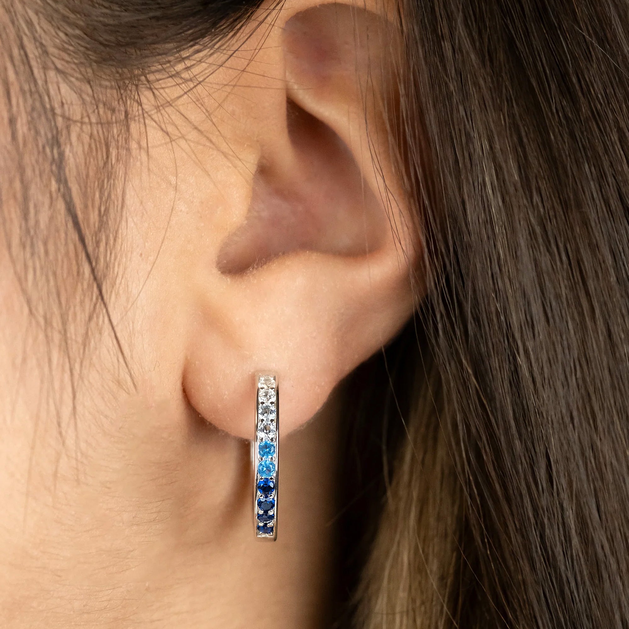 Woman Wearing Sterling Silver Ocean Blue 21mm CZ Hoop Earrings