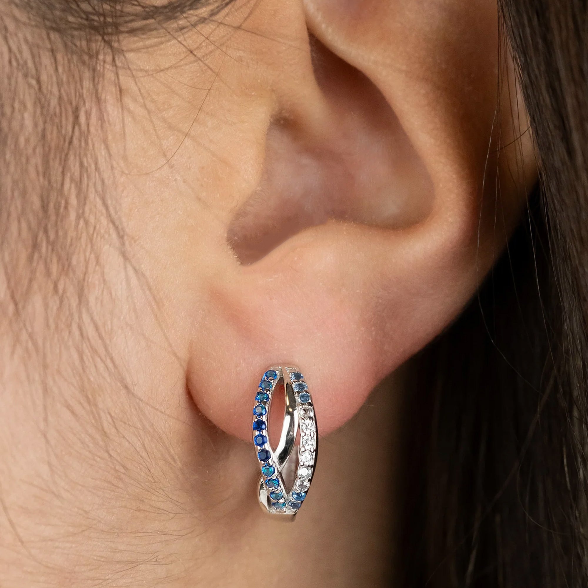 Woman Wearing Sterling Silver Ocean Blue Infinity Paradise CZ Hoop Earrings