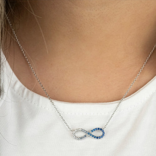 Woman Wearing Sterling Silver Ocean Blue Infinity CZ Necklace
