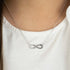 Woman Wearing Sterling Silver Dark Shade Infinity CZ Necklace