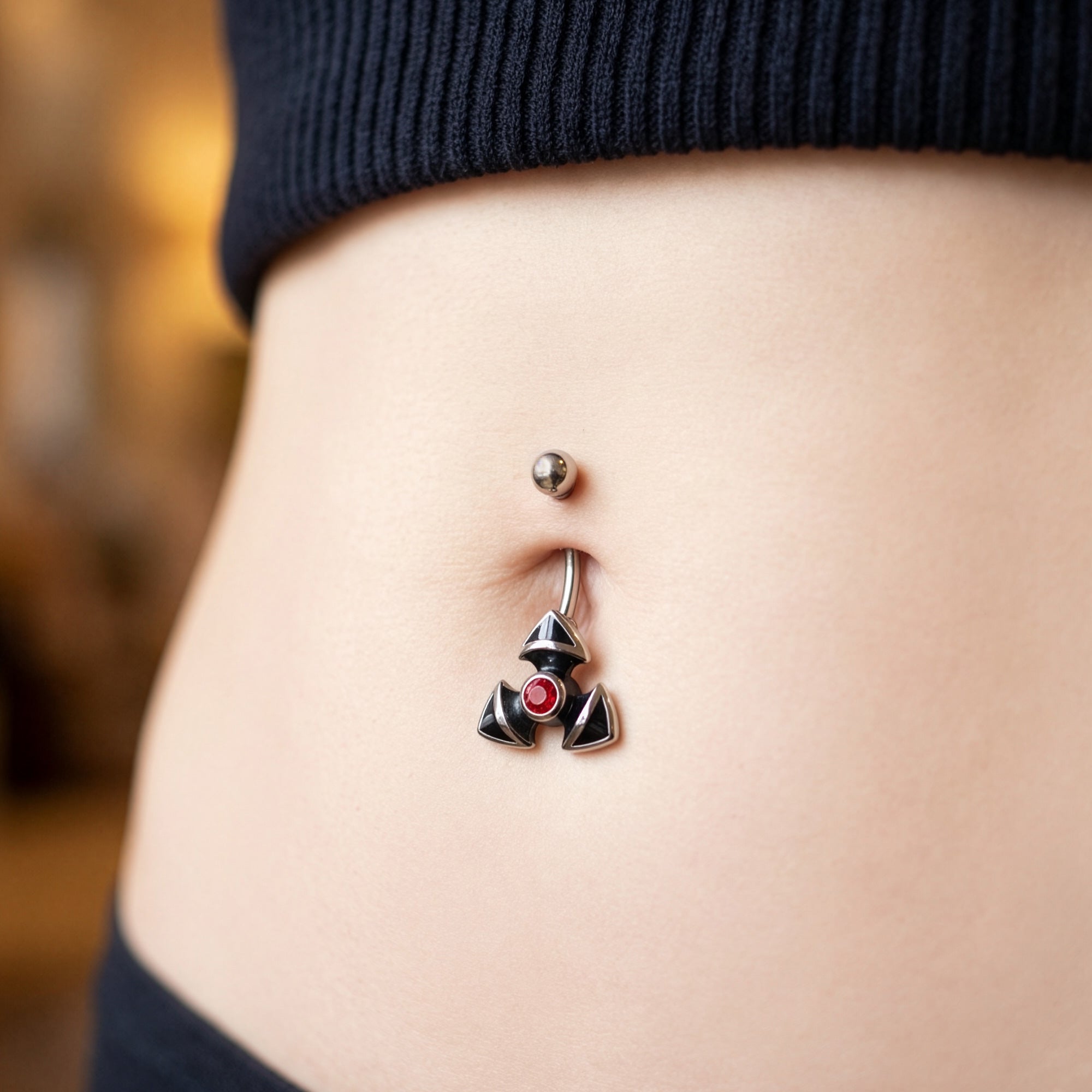 Close Up Woman Wearing Stainless Steel Triad Gothic Belly Bar