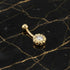 14 Carat Solid Gold CZ Belly Bar Piercing on Marble Table With Gold Seam
