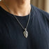 Man In T-Shirt Wering Stainless Steel Men's Cross Shield Necklace