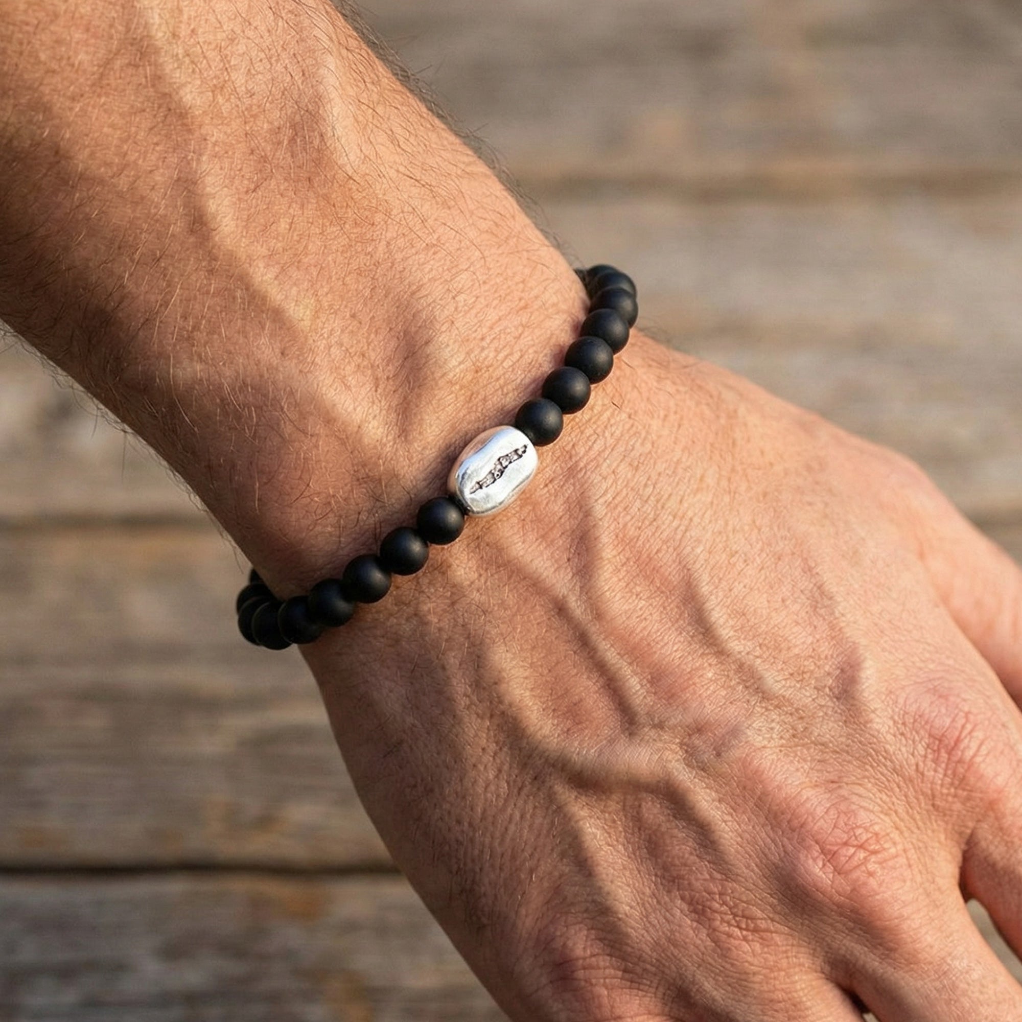 Man wearing Anchor & Crew coffee bean silver black agate stone bracelet
