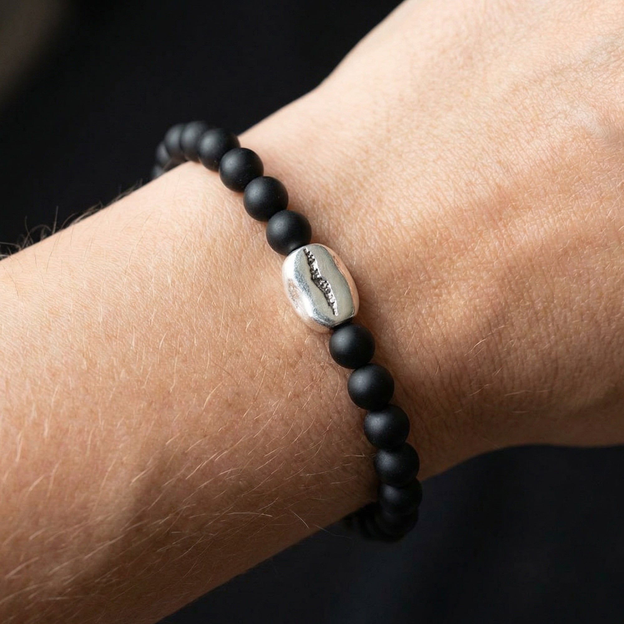 Woman wearing Anchor & Crew coffee bean silver black agate stone bracelet