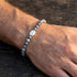 Man wearing Anchor & Crew coffee bean silver grey jasper stone bracelet