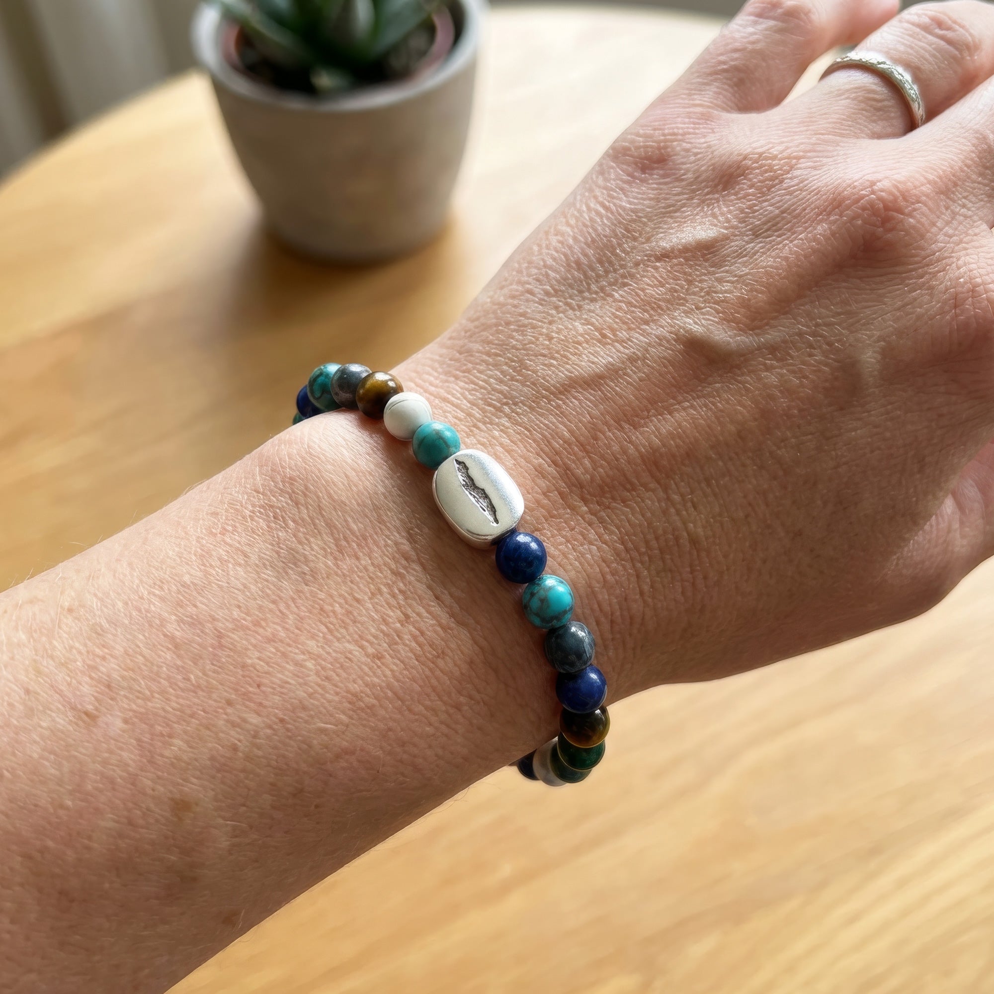 Woman wearing Anchor & Crew coffee bean silver multi-stone bracelet