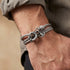Man wearing Anchor & Crew Clyde sterling silver grey rope bracelet.
