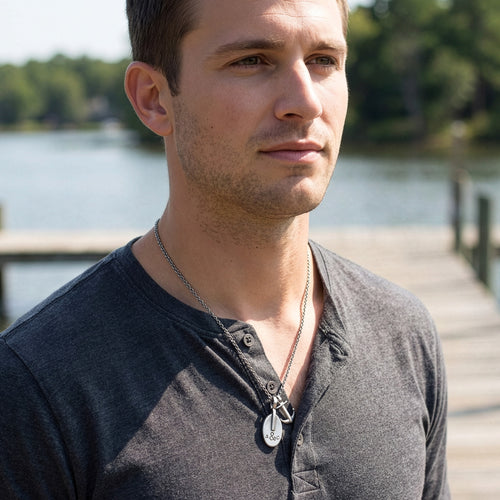 Young man wearing an Anchor & Crew London pulley & anchor sterling silver necklace.