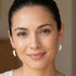 Woman wearing Engelsrufer angel wing sterling silver hook earrings.