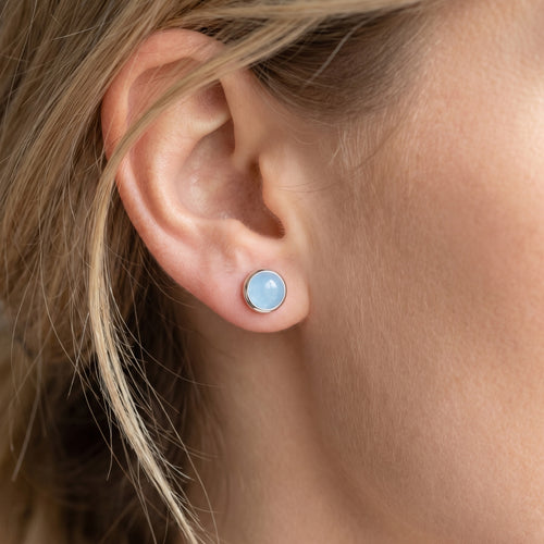 Woman wearing Engelsrufer aquamarine cabochon silver stud earrings.
