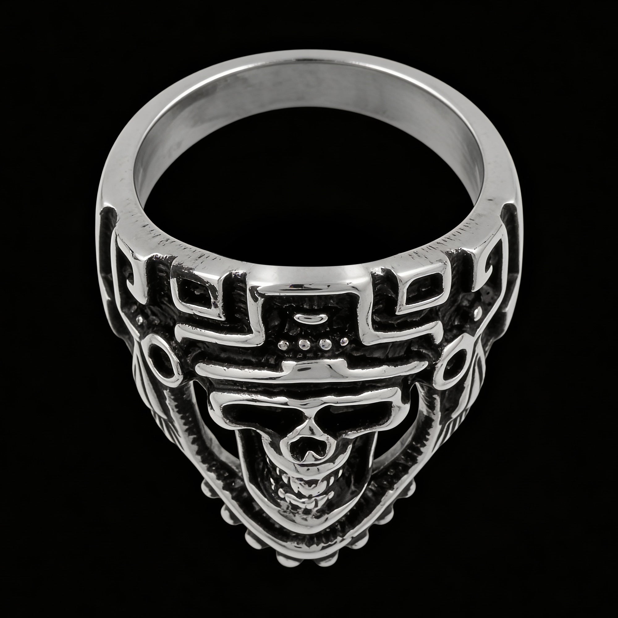 Overheard view of stainless steel men's skull Aztec death mask ring facing left.