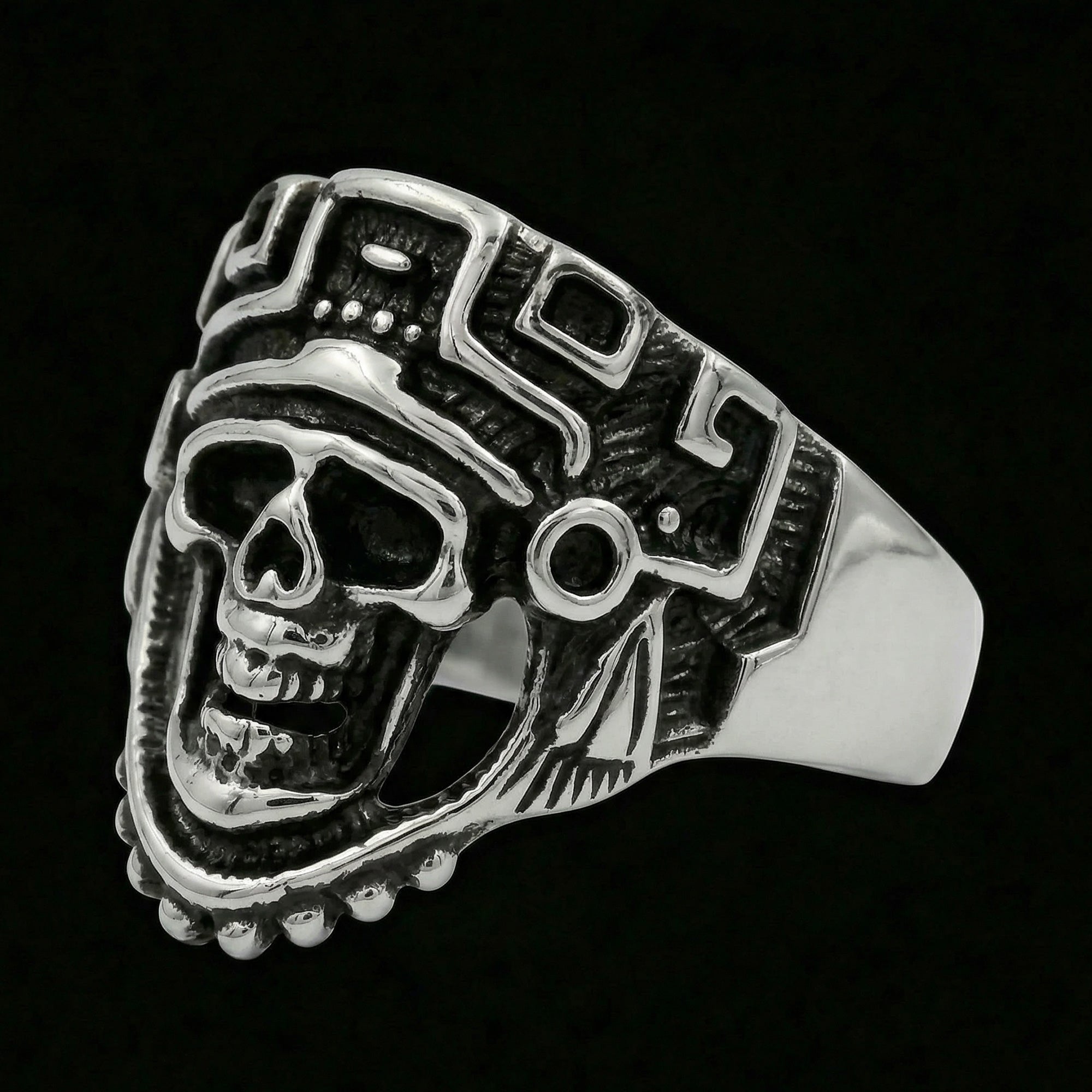 Tilted angle of stainless steel men's skull Aztec death mask ring.