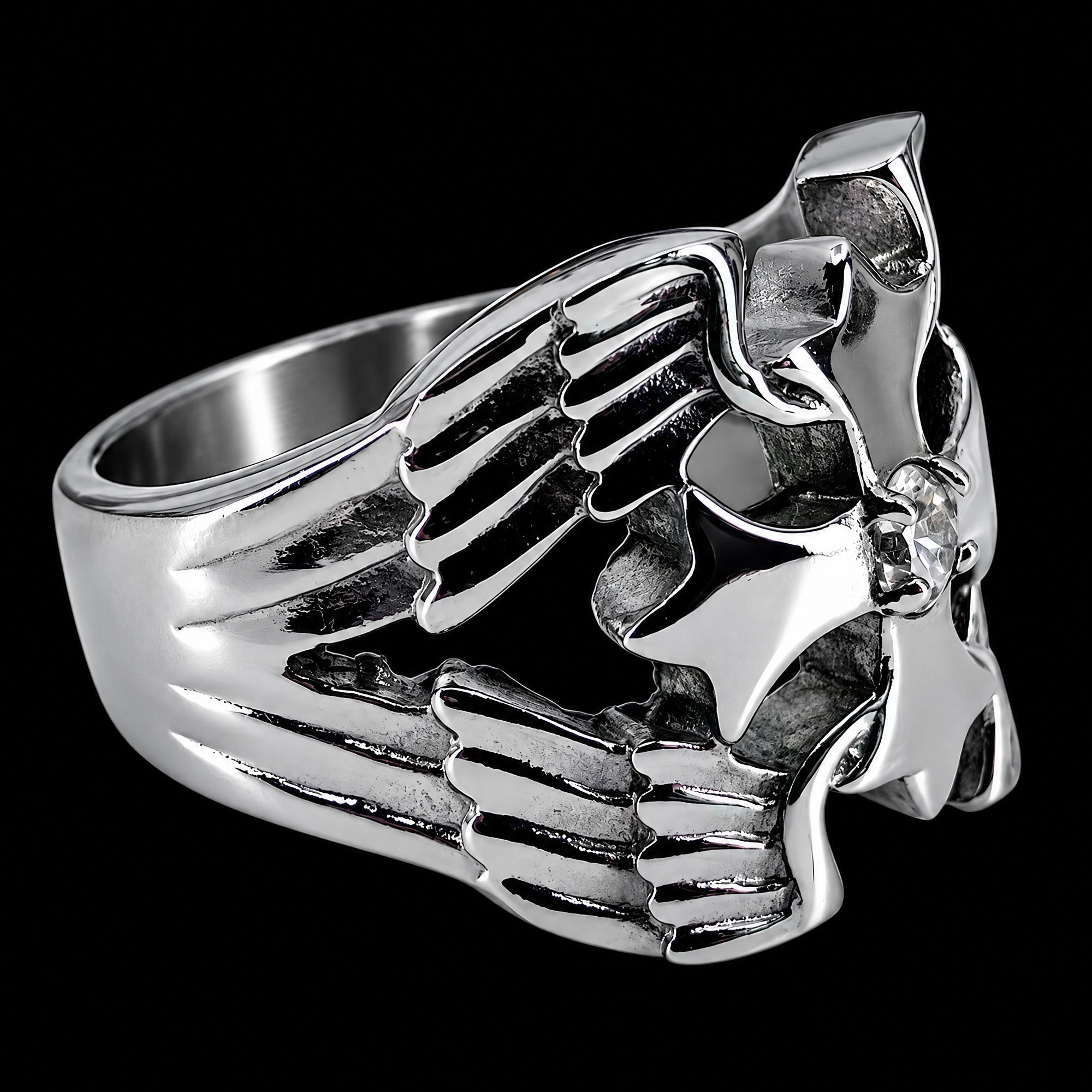 Side view of a winged barbed cross stainless steel men's ring facing right.