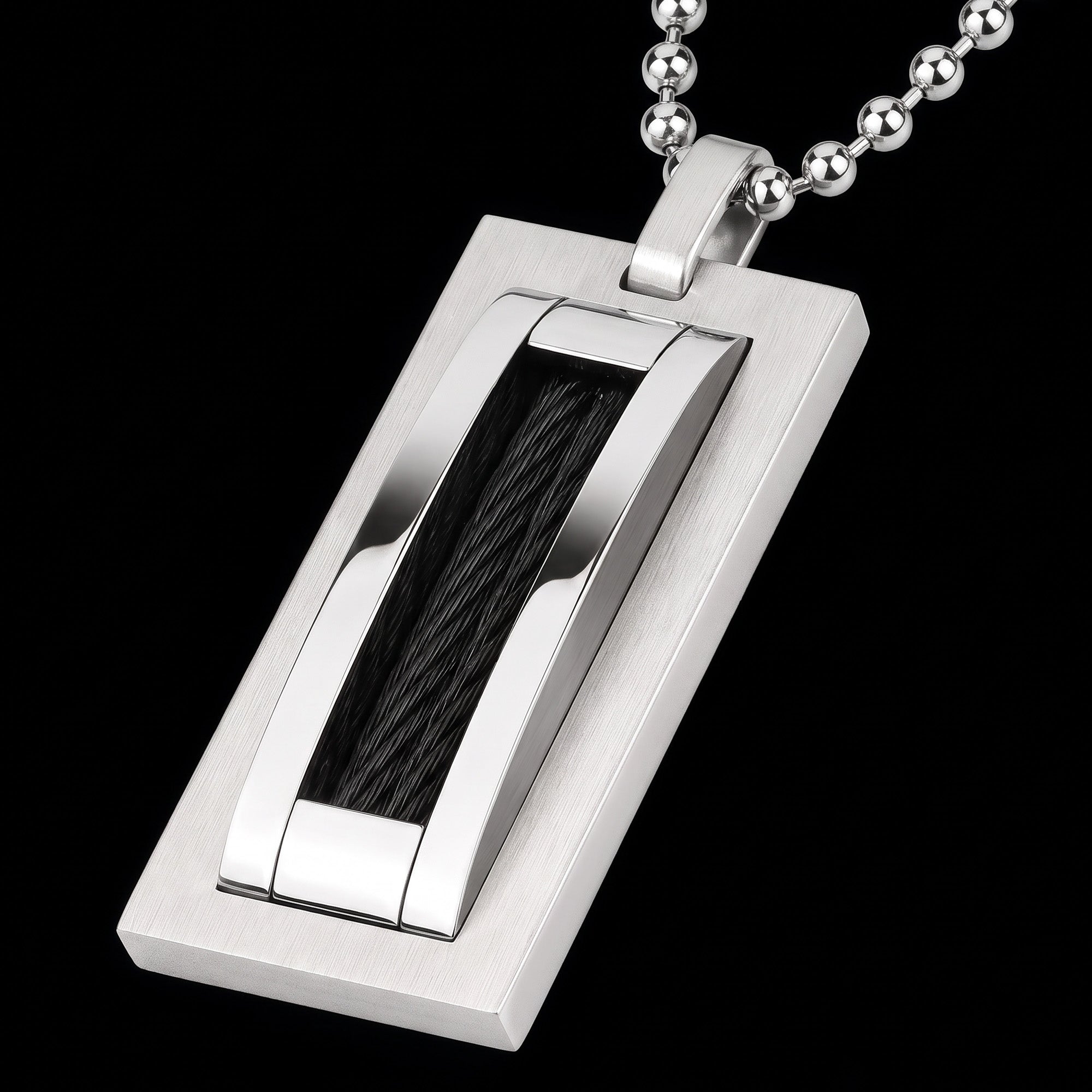 Angle view of a black cable steel dog tag men's necklace.