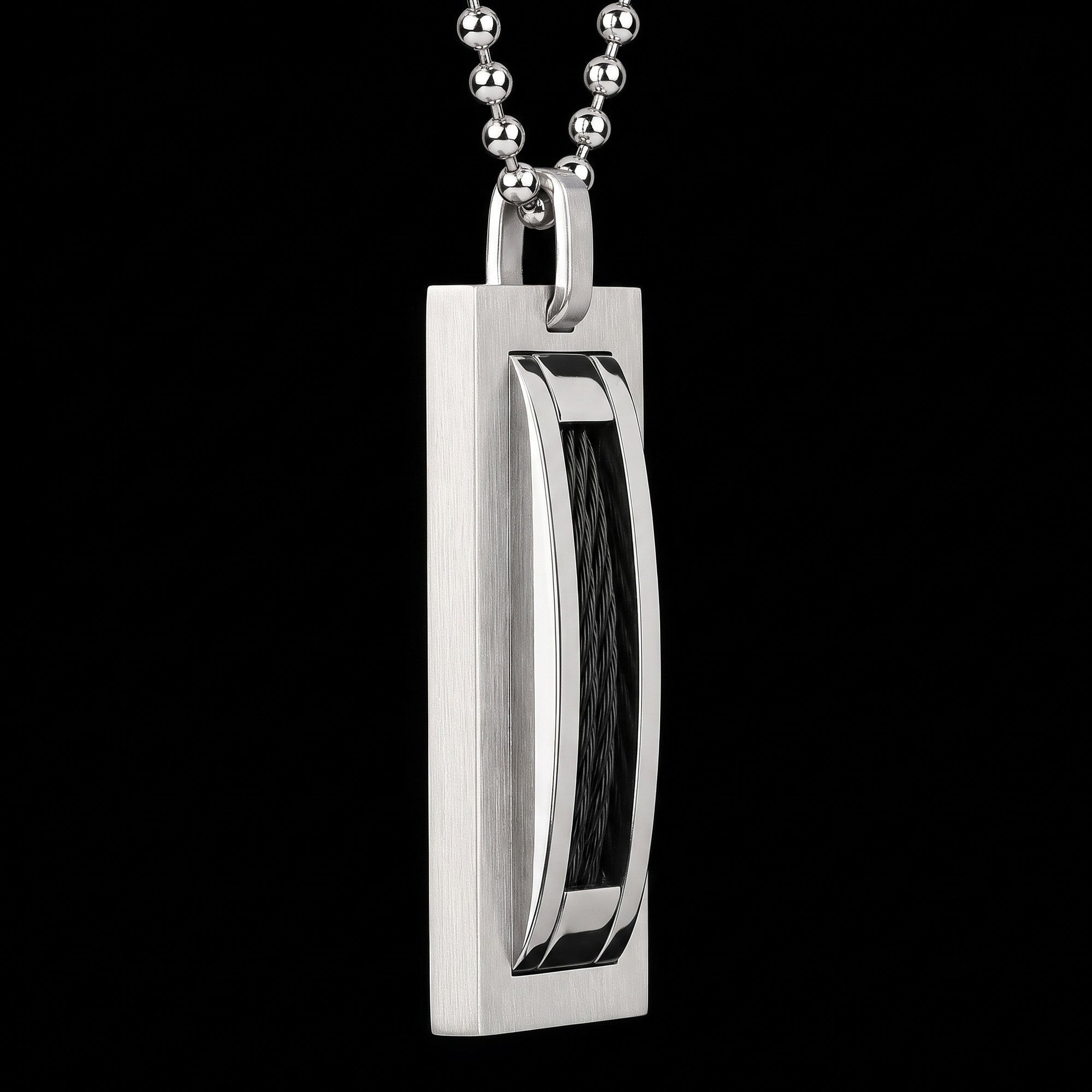 Side tilt view of a a black cable steel dog tag men's necklace.