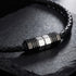 Close-up of Save Brave black leather men's bead necklace on a black stone surface.