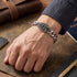 Man wearing a caduceus Cuban link men's stainless steel bracelet.