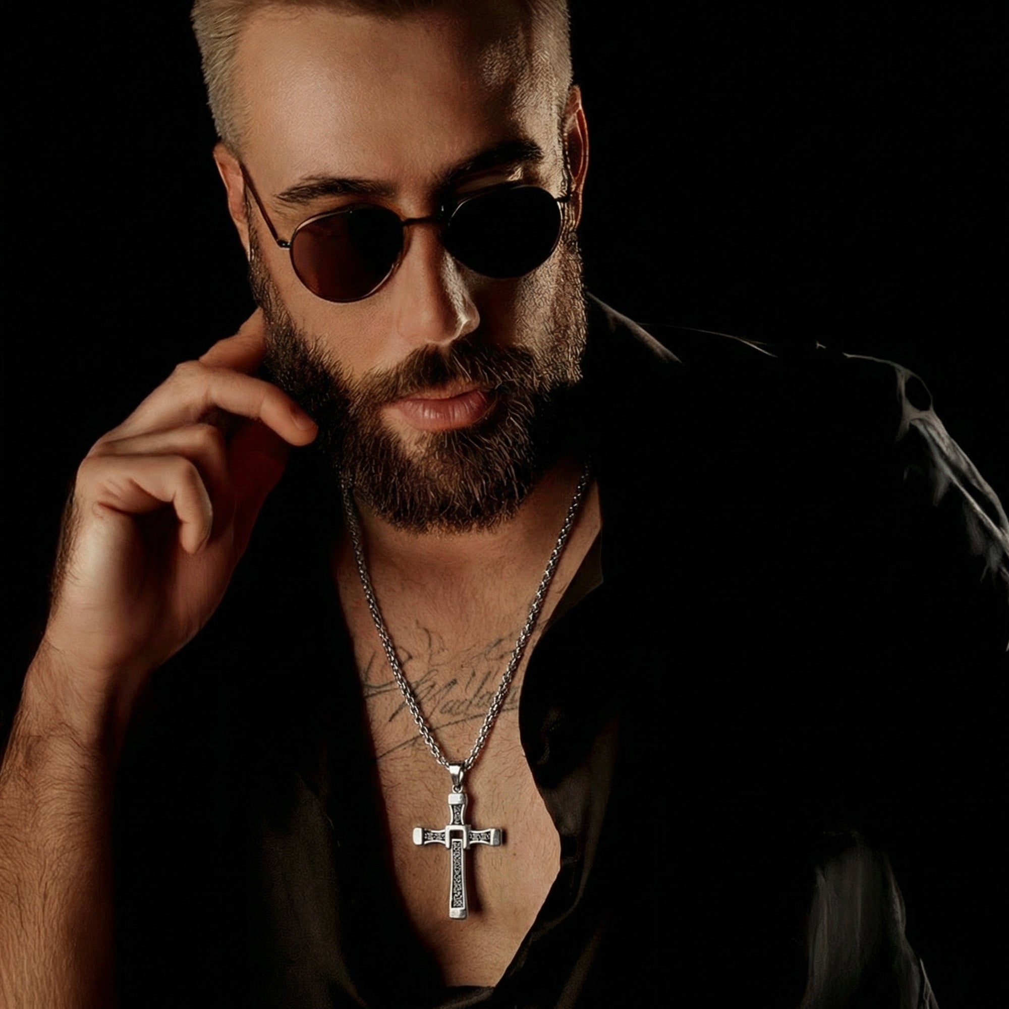 Close-up of beared man in sunglasses wearing celtic runes swivel cross stainless steel necklace.