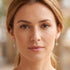 Woman wearing a pair of chandelier scroll Art Deco pave CZ dangle earrings.