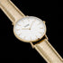 Close-up of Cluse La Boheme gold white/gold metallic watch.