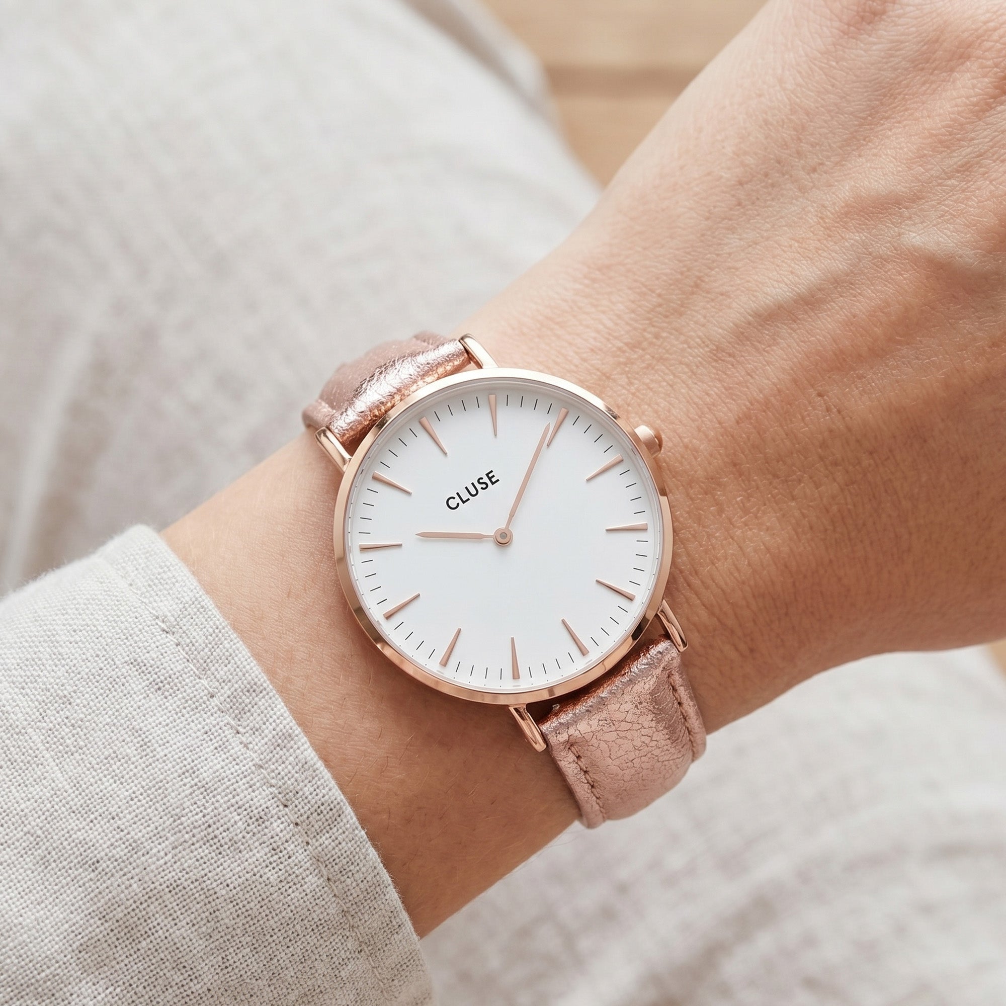Woman wearing Cluse La Boheme rose gold white/rose gold metallic watch.
