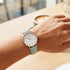 Woman wearing Cluse La Boheme rose gold white/pastel mint green watch.