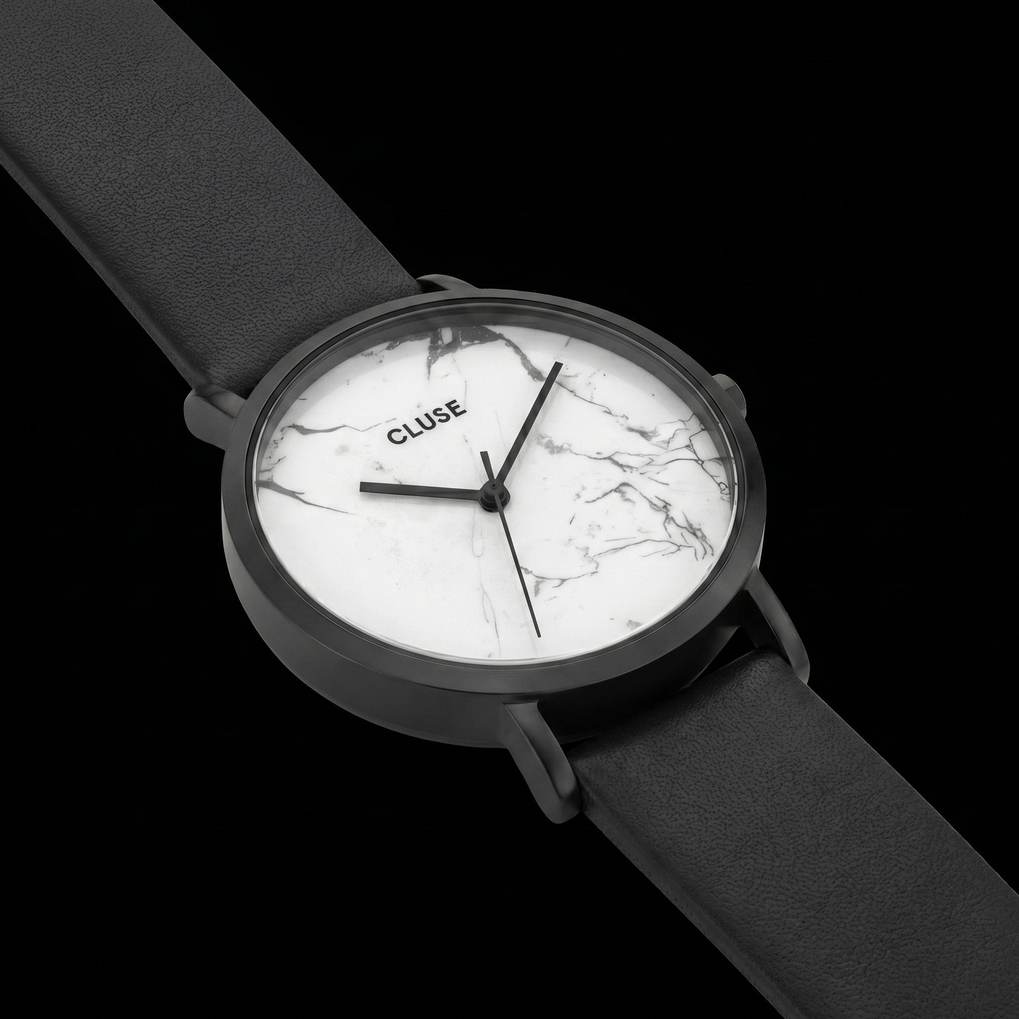 Close-up of Cluse La Roche white marble/black watch.