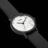 Close-up of Cluse La Roche white marble/black watch.