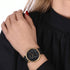 Woman wearing Cluse La Roche gold black marble/black watch.