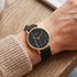 Woman wearing Cluse La Roche gold black marble/black watch.