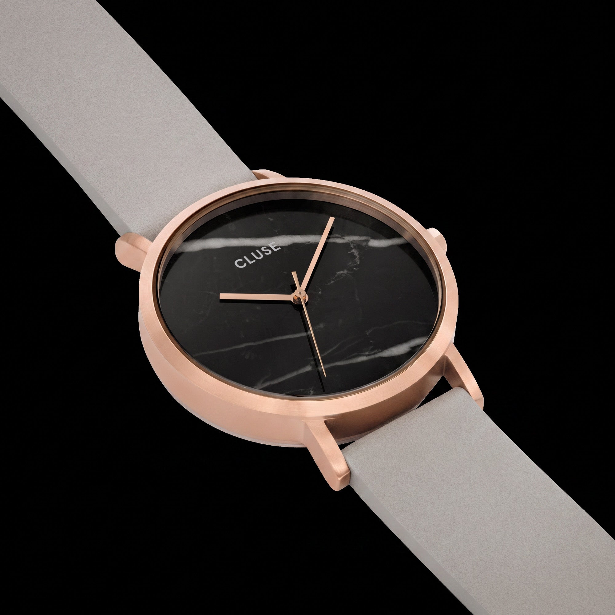 Close-up of Cluse La Roche rose gold black marble/grey watch.