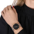 Woman wearing Cluse La Roche rose gold black marble/grey watch.