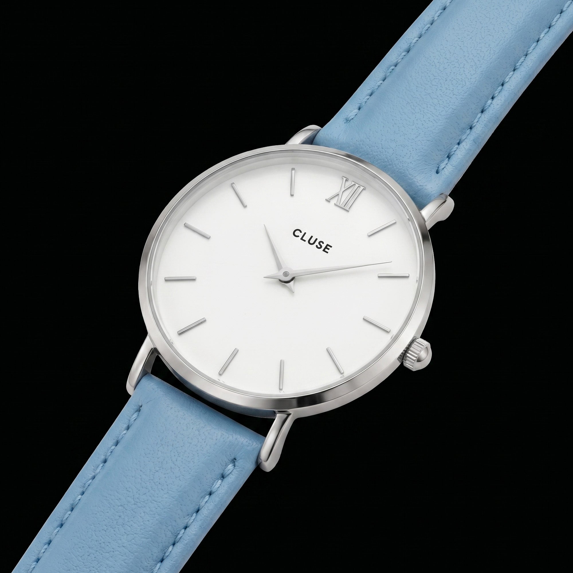 Close-up of Cluse Minuit silver/white baby blue watch.