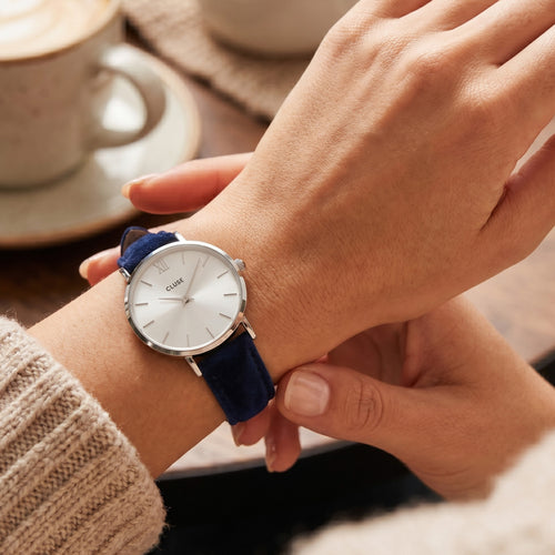 Woman wearing Cluse Minuit silver blue velvet limited edition watch on her wrist.